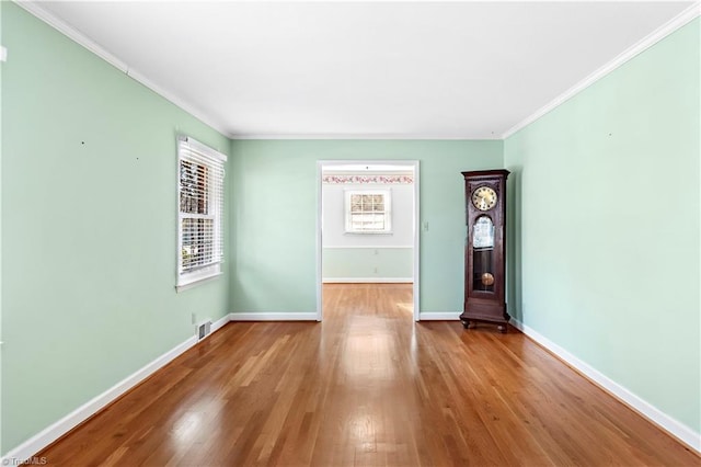 interior space with light hardwood / wood-style flooring and ornamental molding