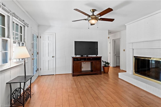 living room featuring ceiling fan and light hardwood / wood-style floors