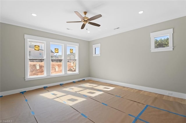 unfurnished room with a wealth of natural light, crown molding, and baseboards