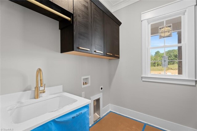 clothes washing area with washer hookup, a sink, baseboards, cabinet space, and electric dryer hookup