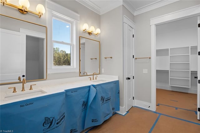 bathroom with ornamental molding, a sink, and double vanity