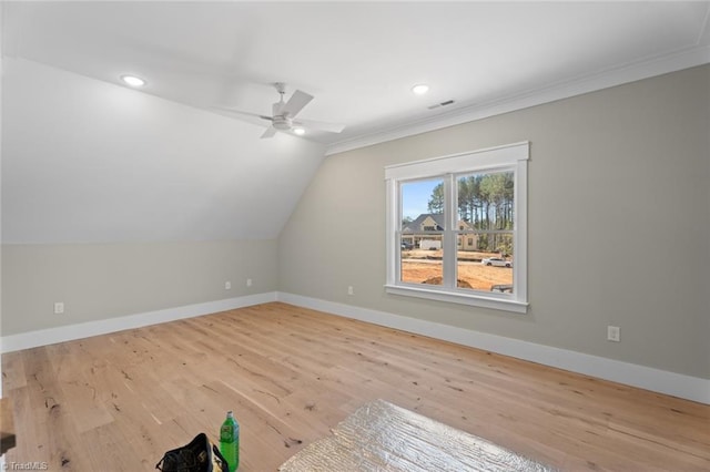 bonus room with light wood-style flooring, visible vents, vaulted ceiling, and baseboards