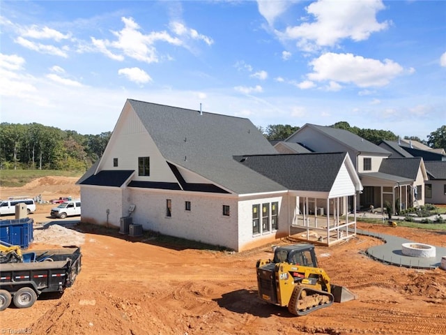 back of house with central AC