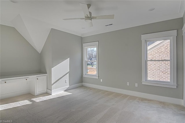 additional living space with light carpet, a ceiling fan, visible vents, and baseboards