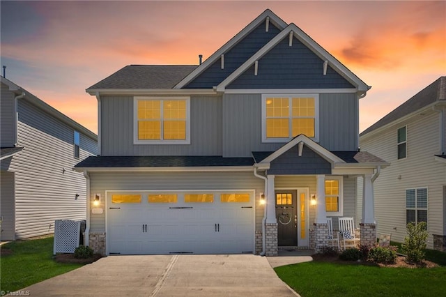 2177 Campbell Loop, Burlington, NC 27215 - craftsman-style house featuring driveway, an attached garage, covered porch, stone siding, and a front yard