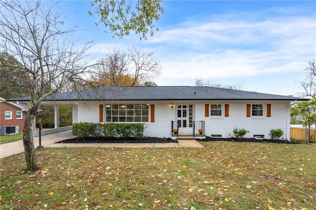 ranch-style house featuring a carport, a front yard, and central AC unit