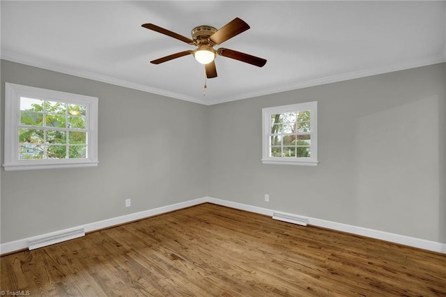 empty room with ornamental molding, ceiling fan, and light hardwood / wood-style floors