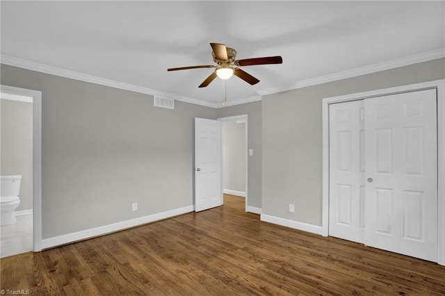 unfurnished bedroom featuring crown molding, ceiling fan, connected bathroom, and hardwood / wood-style floors