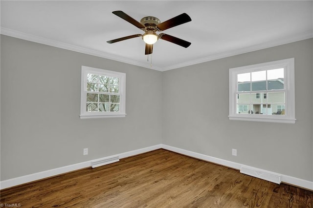 unfurnished room with crown molding, plenty of natural light, and light wood-type flooring