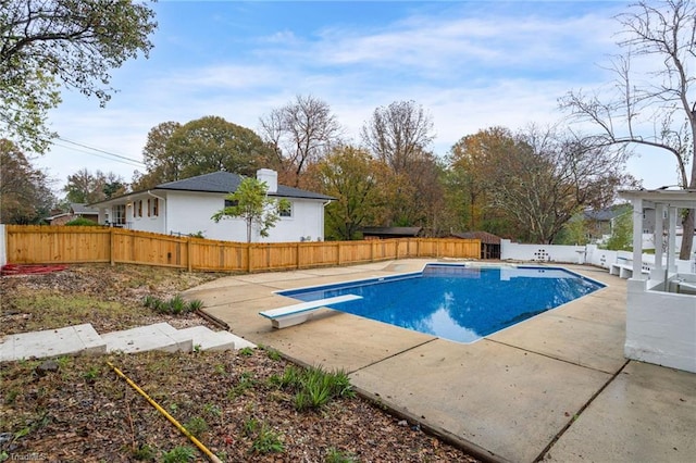 view of pool featuring a patio and a diving board