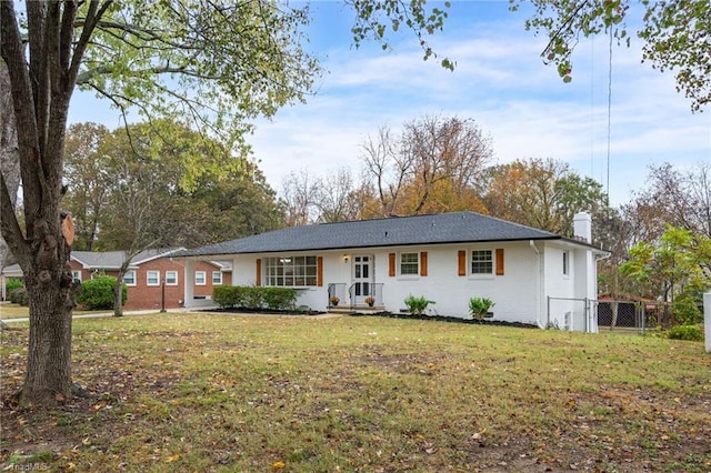 ranch-style home with a front lawn