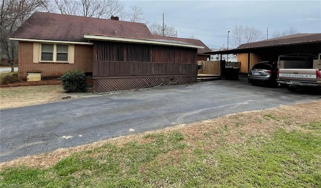 view of side of property with a carport