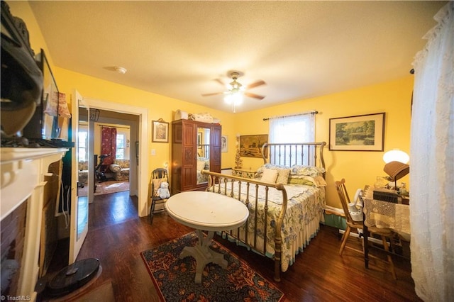 bedroom featuring ceiling fan, dark hardwood / wood-style floors, and multiple windows