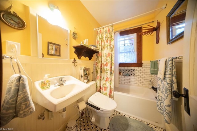 full bathroom featuring shower / bath combo, toilet, sink, and tile patterned floors