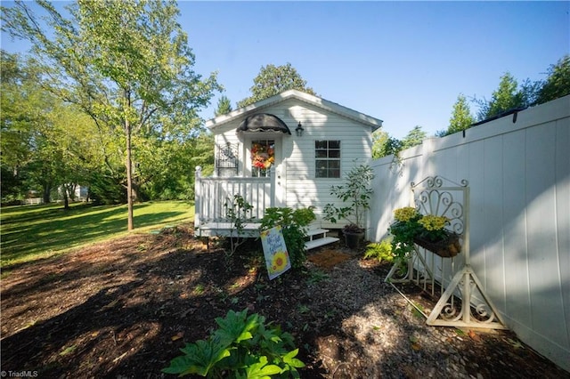 exterior space featuring a lawn and a deck