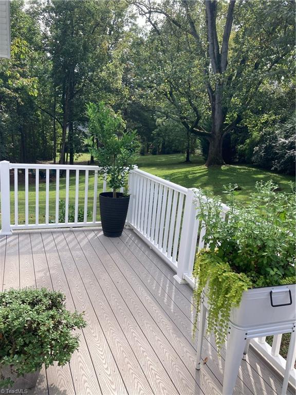 wooden terrace featuring a lawn