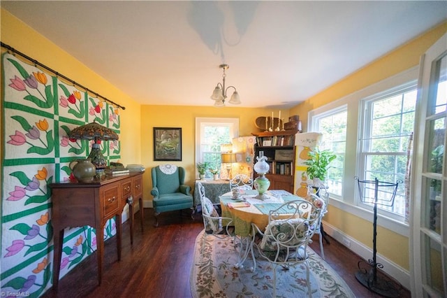 dining area featuring a chandelier, dark hardwood / wood-style flooring, and a healthy amount of sunlight