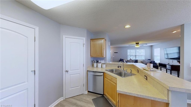 kitchen featuring sink, light hardwood / wood-style flooring, dishwasher, a textured ceiling, and kitchen peninsula