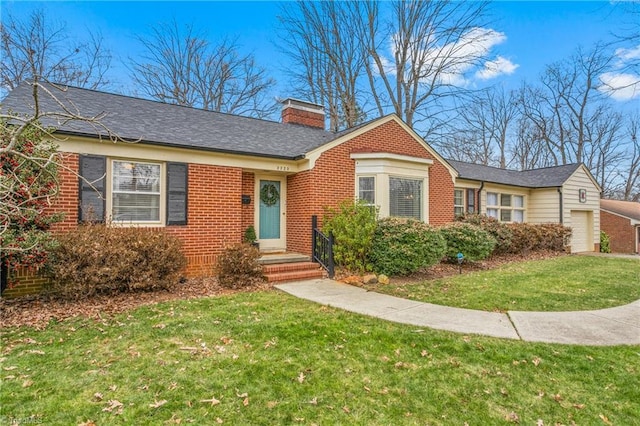 view of front of house with a garage and a front yard