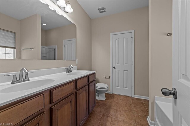 bathroom with a shower with door, toilet, double vanity, and a sink