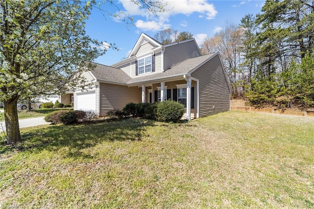 traditional-style house with driveway, a garage, and a front lawn