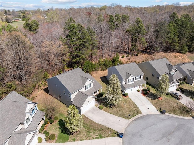 birds eye view of property with a wooded view