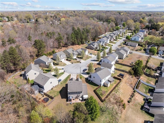 drone / aerial view with a residential view and a wooded view