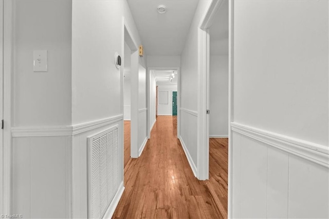 corridor with light wood-type flooring