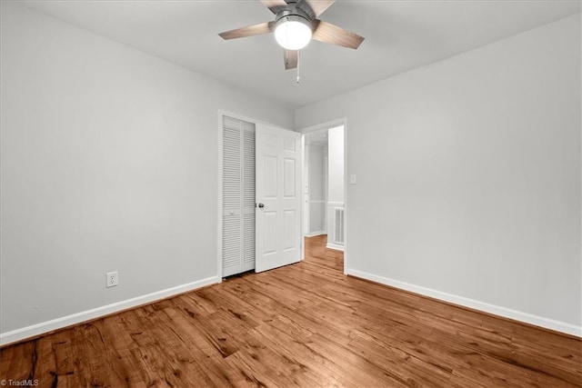 empty room with ceiling fan and light wood-type flooring