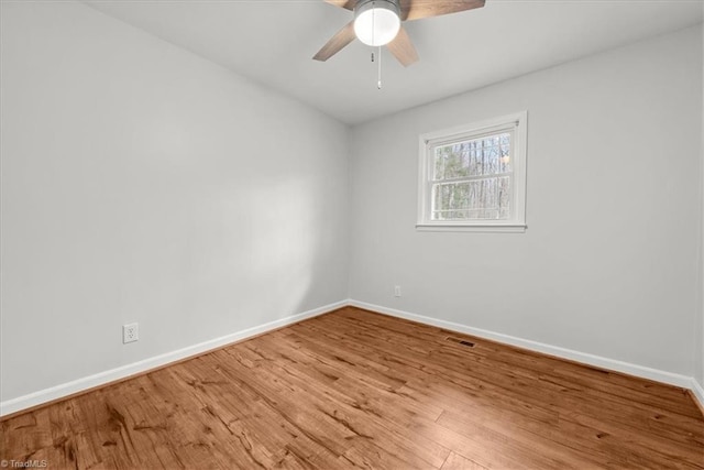 empty room featuring wood-type flooring and ceiling fan