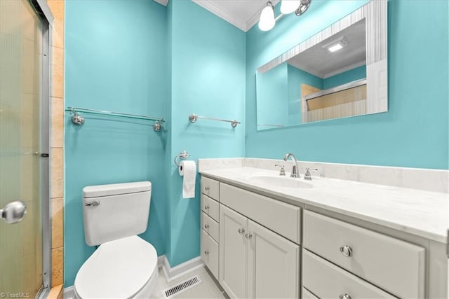 bathroom featuring vanity, a shower with door, ornamental molding, and toilet