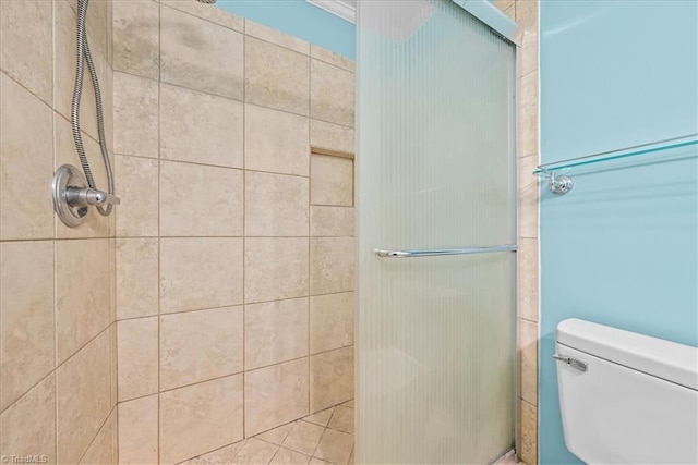 bathroom featuring toilet and an enclosed shower