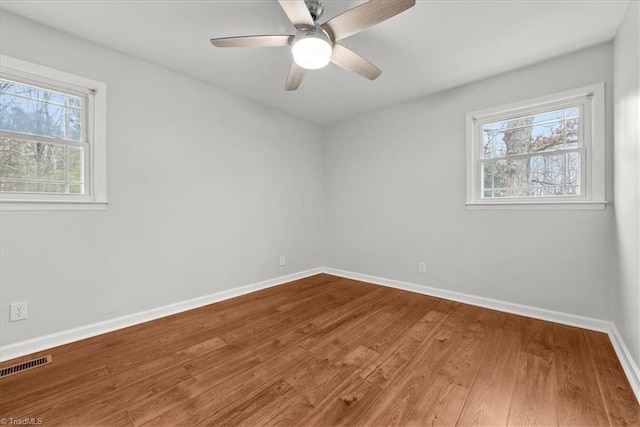 unfurnished room with hardwood / wood-style floors and ceiling fan