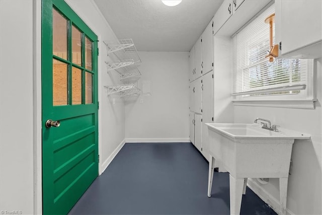 laundry area with a textured ceiling