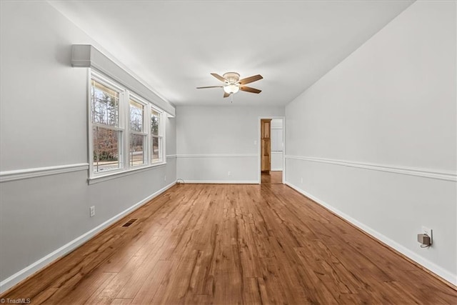 empty room featuring light hardwood / wood-style flooring and ceiling fan