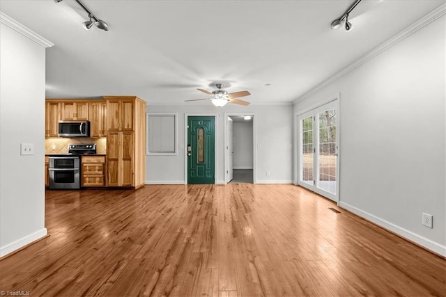 unfurnished living room featuring crown molding, hardwood / wood-style flooring, rail lighting, and ceiling fan