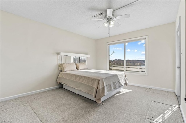 bedroom featuring carpet, visible vents, baseboards, ceiling fan, and a textured ceiling