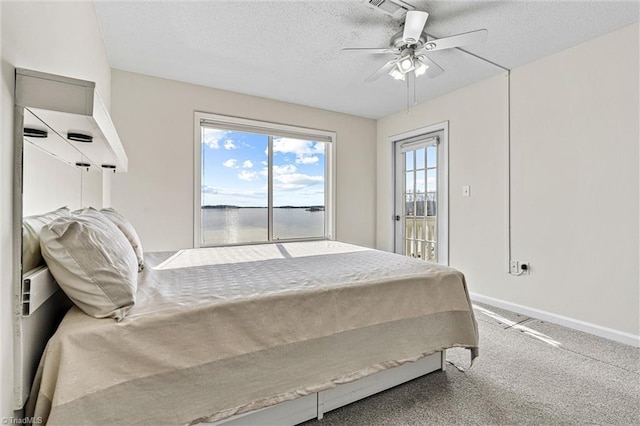 carpeted bedroom with baseboards, a textured ceiling, a ceiling fan, and access to outside