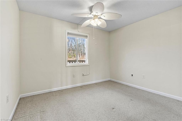 spare room with baseboards, a textured ceiling, ceiling fan, and carpet flooring