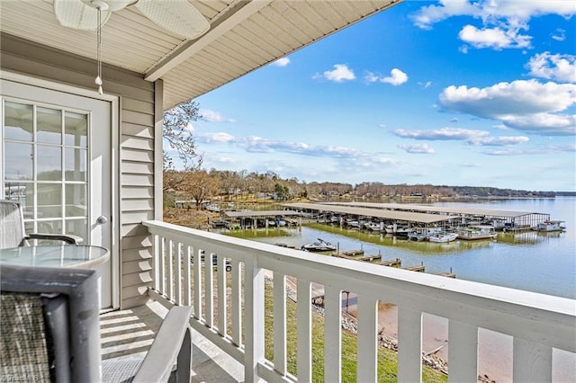balcony with a water view and a floating dock
