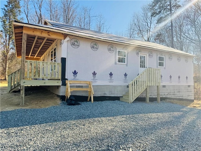 exterior space with crawl space and a wooden deck