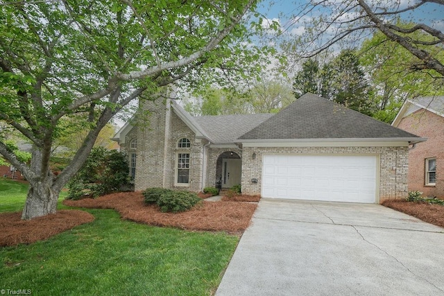 143 Wellesborough Rd, Winston-Salem, NC 27104 - view of front of property with roof with shingles, a garage, concrete driveway, and brick siding