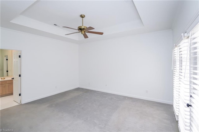 143 Wellesborough Rd, Winston-Salem, NC 27104 - spare room featuring light carpet, baseboards, a ceiling fan, and a raised ceiling