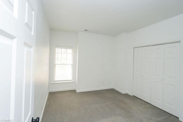 143 Wellesborough Rd, Winston-Salem, NC 27104 - unfurnished bedroom featuring a closet, visible vents, baseboards, and carpet