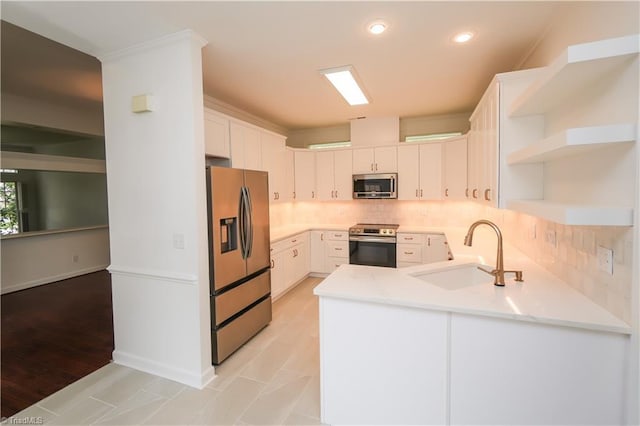 143 Wellesborough Rd, Winston-Salem, NC 27104 - kitchen with a peninsula, light countertops, open shelves, stainless steel appliances, and a sink