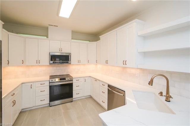 143 Wellesborough Rd, Winston-Salem, NC 27104 - kitchen with white cabinetry, open shelves, a sink, stainless steel appliances, and decorative backsplash