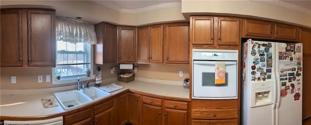 kitchen featuring white appliances, sink, and ornamental molding