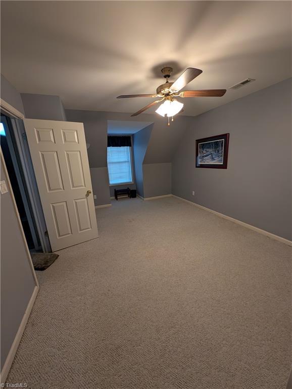 additional living space featuring ceiling fan, carpet flooring, and vaulted ceiling