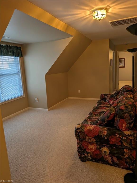 interior space with vaulted ceiling and carpet flooring