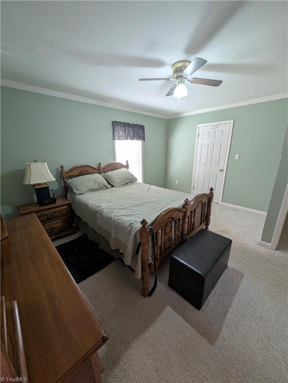 carpeted bedroom with crown molding and ceiling fan